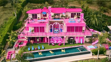 A large house made up to look like a Barbie Dream House, which is all pink